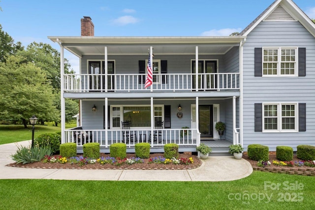 16612 Grapperhall Dr, Huntersville, NC 28078 - view of front facade featuring a balcony, a chimney, a porch, and a front yard