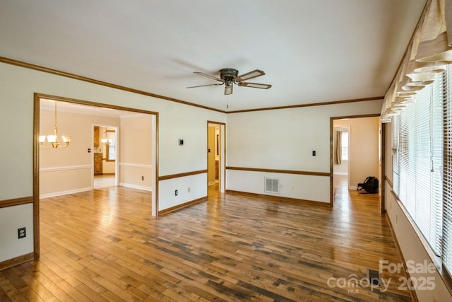 16612 Grapperhall Dr, Huntersville, NC 28078 - unfurnished room with a chandelier, hardwood / wood-style flooring, ceiling fan, baseboards, and crown molding