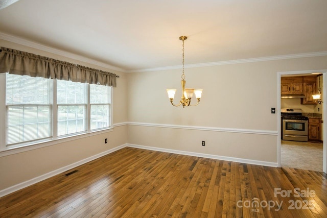 16612 Grapperhall Dr, Huntersville, NC 28078 - unfurnished dining area with ornamental molding, wood-type flooring, a chandelier, and baseboards