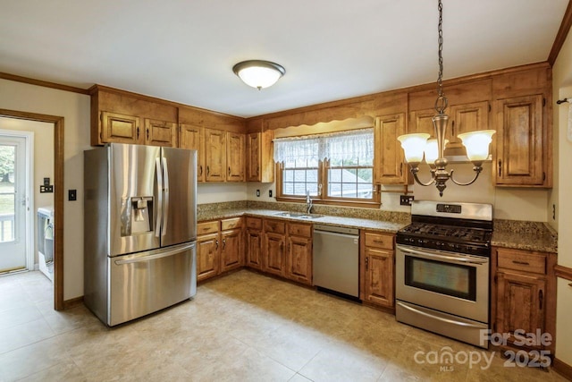 16612 Grapperhall Dr, Huntersville, NC 28078 - kitchen with stainless steel appliances, brown cabinetry, a sink, a chandelier, and decorative light fixtures