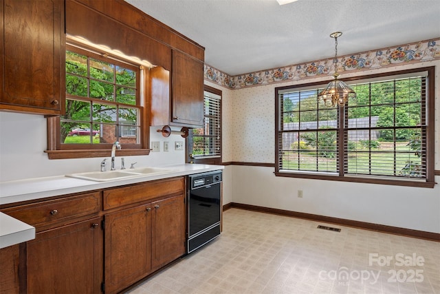 1940 12th St NE, Hickory, NC 28601 - kitchen featuring black dishwasher, a sink, a chandelier, baseboards, and light countertops