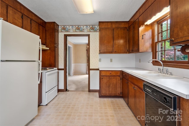 1940 12th St NE, Hickory, NC 28601 - kitchen with white appliances, wallpapered walls, a sink, light countertops, and light floors