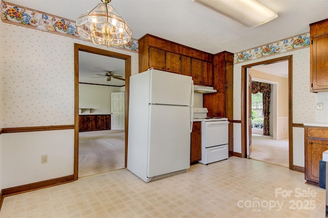 1940 12th St NE, Hickory, NC 28601 - kitchen featuring white appliances, wallpapered walls, under cabinet range hood, light floors, and a chandelier