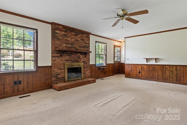 1940 12th St NE, Hickory, NC 28601 - unfurnished living room featuring a wainscoted wall, wooden walls, ornamental molding, carpet, and a ceiling fan