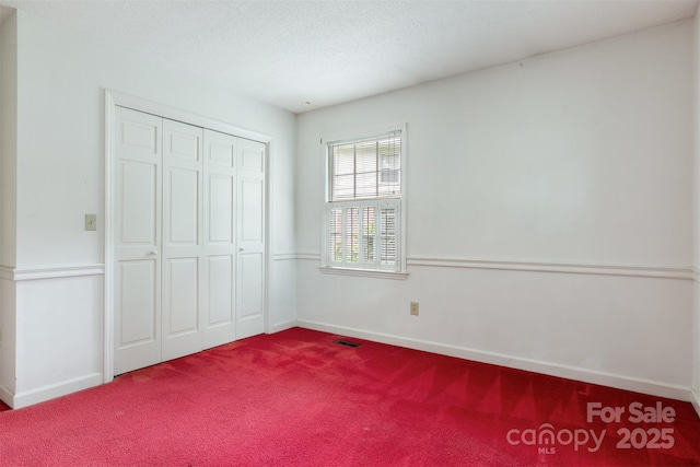 1940 12th St NE, Hickory, NC 28601 - unfurnished bedroom with carpet, baseboards, and a closet