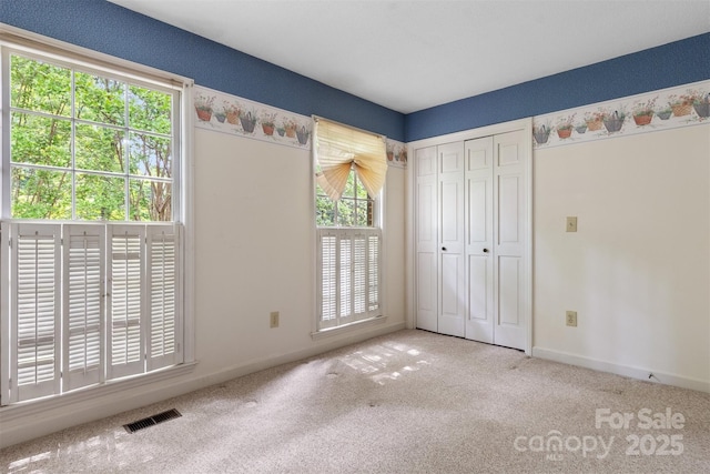 1940 12th St NE, Hickory, NC 28601 - unfurnished bedroom with carpet flooring, baseboards, and a closet