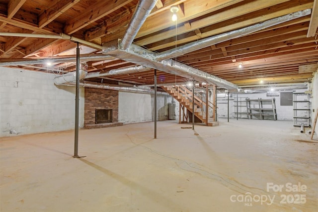 1940 12th St NE, Hickory, NC 28601 - unfinished below grade area with a brick fireplace, stairway, gas water heater, and electric panel