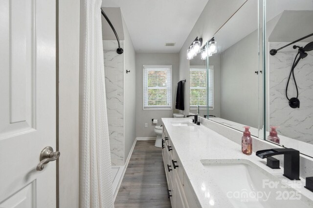 4516 Kiser Island Rd Unit 1, Terrell, NC 28682 - full bath featuring wood finished floors, a stall shower, double vanity, toilet, and baseboards