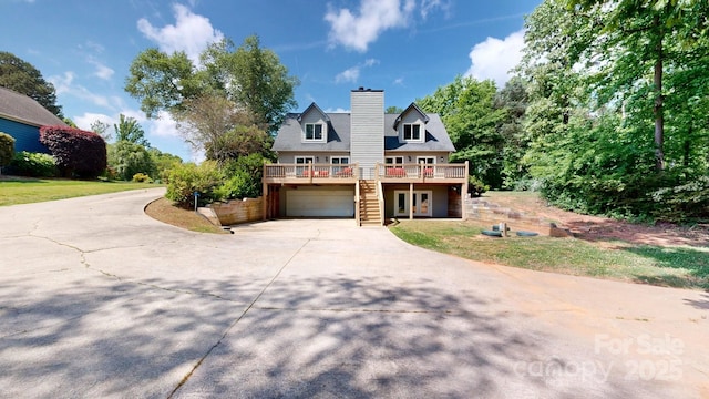 4516 Kiser Island Rd Unit 1, Terrell, NC 28682 - view of front of house featuring a wooden deck, concrete driveway, a garage, and a chimney