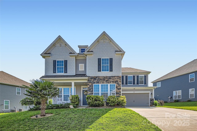 view of front facade featuring concrete driveway, stone siding, a front lawn, and a garage