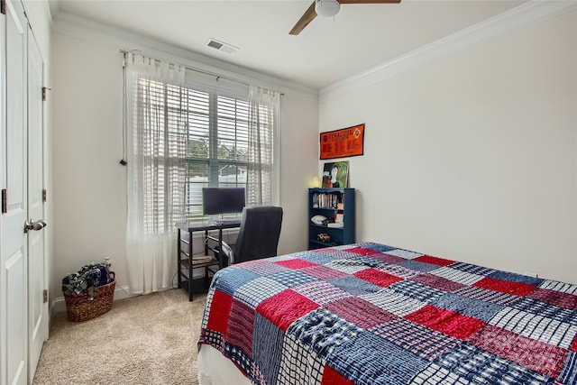 bedroom featuring light carpet, ornamental molding, and a ceiling fan