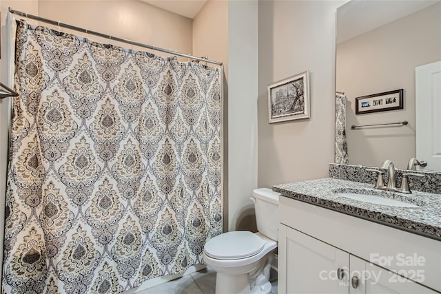 full bathroom featuring toilet, tile patterned floors, and vanity