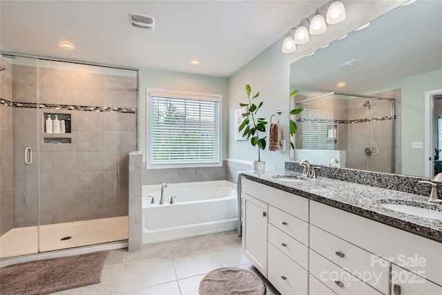 full bath featuring tile patterned flooring, a shower stall, a bath, double vanity, and recessed lighting