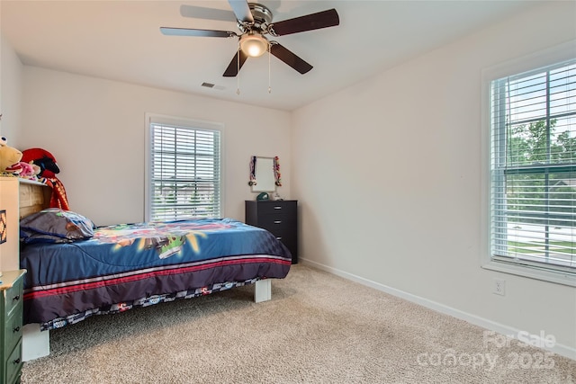 bedroom featuring multiple windows, carpet, baseboards, and ceiling fan