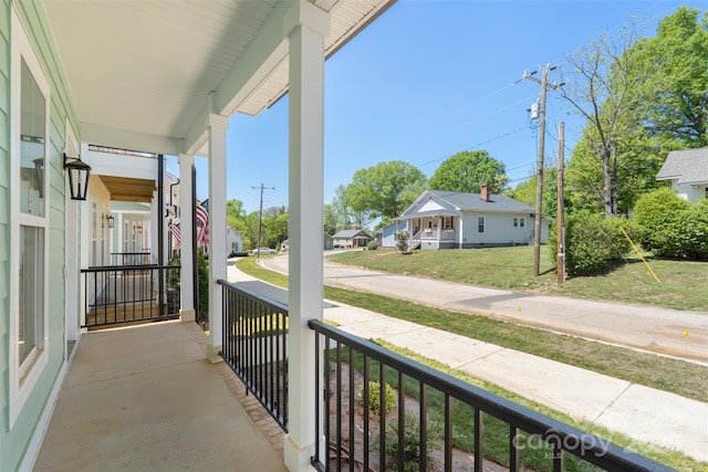 balcony with covered porch and a residential view