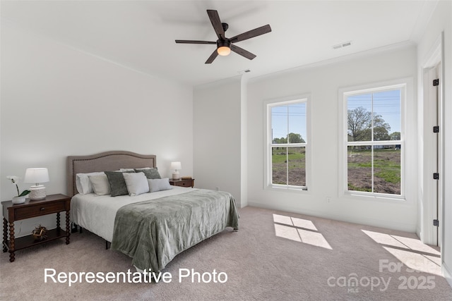 bedroom with carpet flooring, crown molding, baseboards, and a ceiling fan