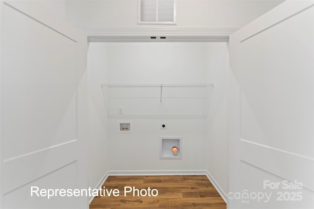 laundry room with hookup for an electric dryer, wood finished floors, hookup for a washing machine, and baseboards
