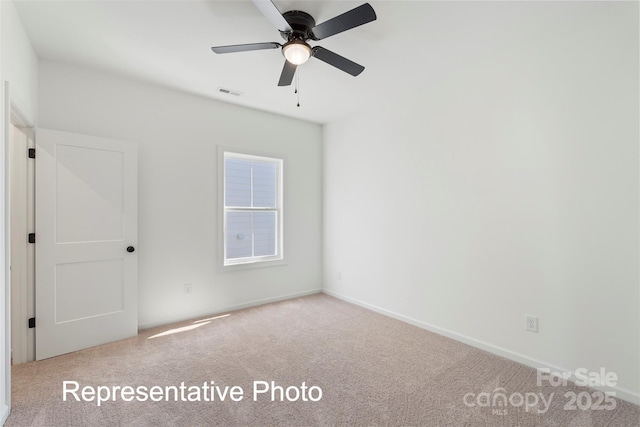 empty room with carpet flooring, ceiling fan, and baseboards