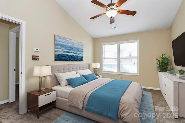 carpeted bedroom with vaulted ceiling, baseboards, and a ceiling fan