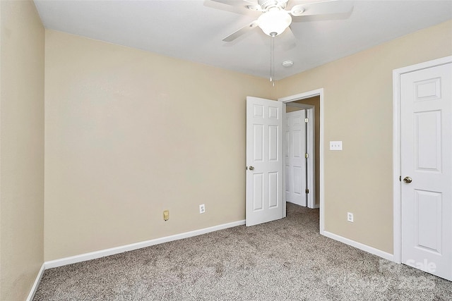 unfurnished bedroom with carpet flooring, baseboards, and a ceiling fan