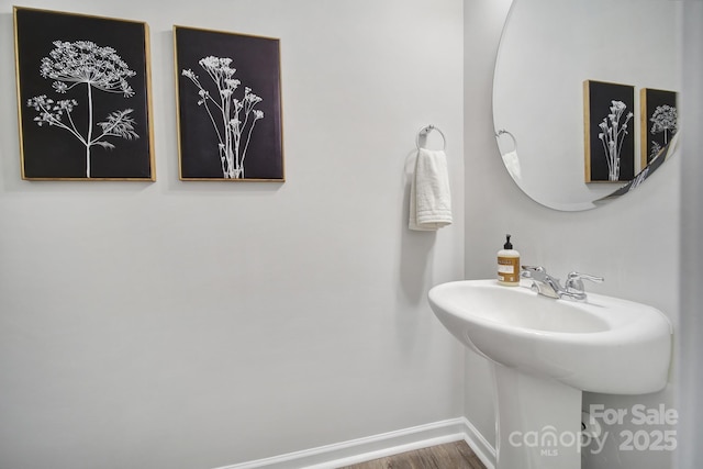 bathroom featuring baseboards and wood finished floors