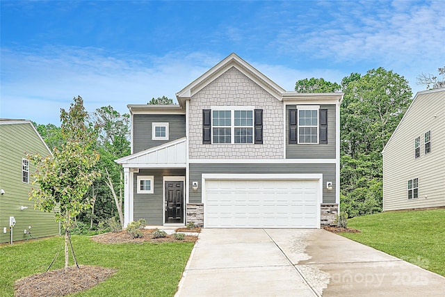 view of front of home featuring driveway, a garage, a front yard, and stone siding
