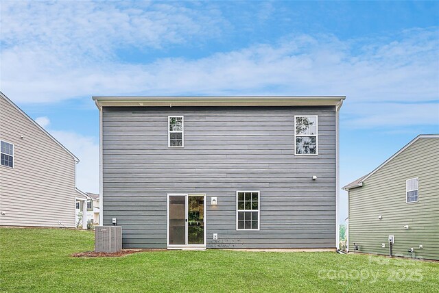 back of house featuring a yard and cooling unit