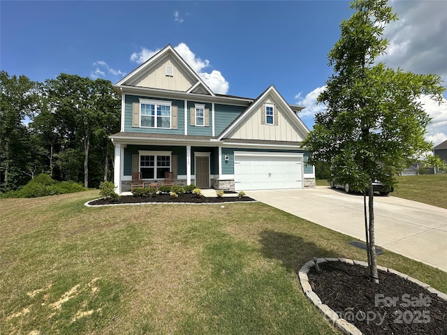 craftsman-style home with a porch, driveway, board and batten siding, a front lawn, and stone siding