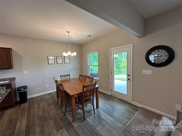 dining area featuring dark wood-style floors, a chandelier, and baseboards