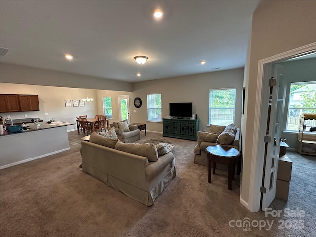 carpeted living area with recessed lighting and baseboards