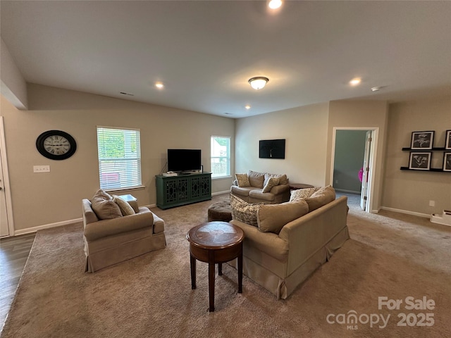 living area featuring healthy amount of natural light, recessed lighting, baseboards, and carpet flooring