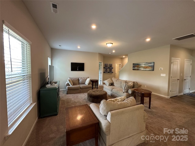 carpeted living area featuring baseboards and recessed lighting