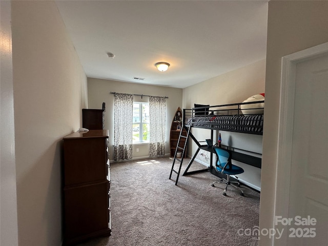 bedroom with carpet floors and baseboards