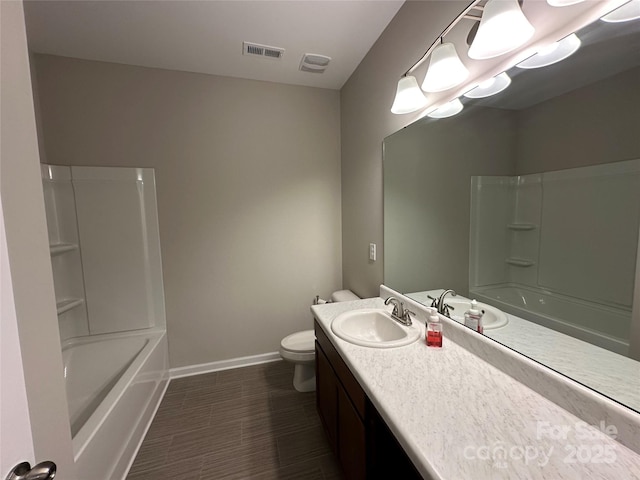 bathroom with baseboards, vanity, toilet, and shower / bath combination