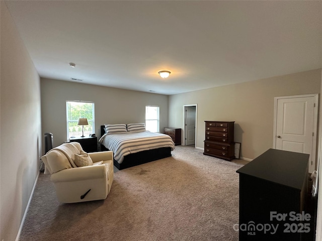 carpeted bedroom featuring baseboards