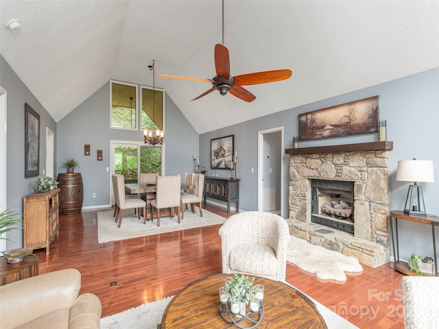14 Bellewood Dr, Maggie Valley, NC 28751 - living area with wood finished floors, a ceiling fan, a fireplace, high vaulted ceiling, and a chandelier
