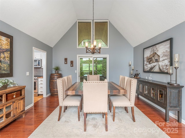 14 Bellewood Dr, Maggie Valley, NC 28751 - dining area featuring a chandelier, wood finished floors, and high vaulted ceiling