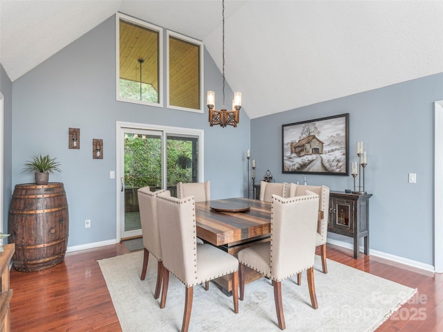 14 Bellewood Dr, Maggie Valley, NC 28751 - dining room with high vaulted ceiling, a chandelier, wood finished floors, and baseboards