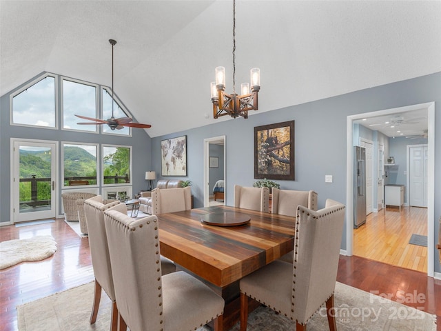14 Bellewood Dr, Maggie Valley, NC 28751 - dining space with a ceiling fan, vaulted ceiling, wood finished floors, a chandelier, and baseboards