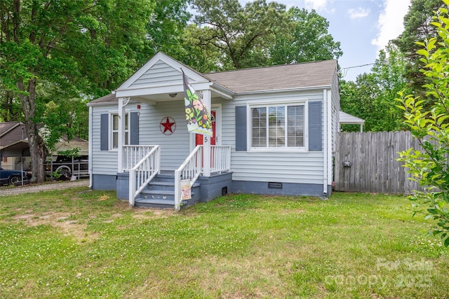 bungalow-style house with crawl space, roof with shingles, and a carport