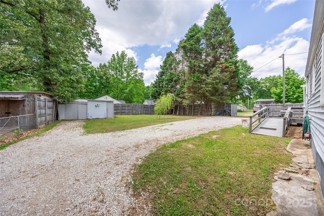 view of yard with a storage shed and an outbuilding