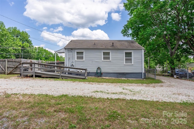 rear view of property featuring a deck