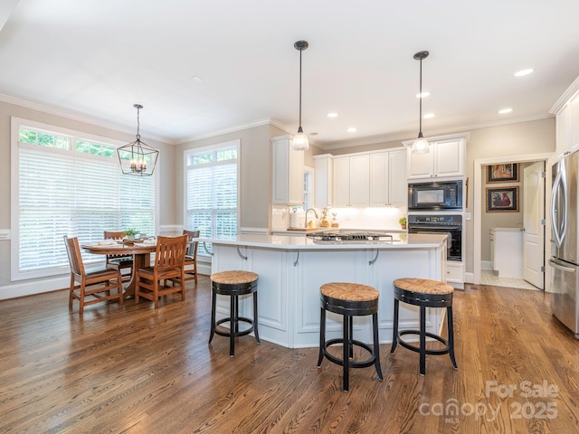 7040 Edenderry Dr, Charlotte, NC 28270 - kitchen featuring black appliances, crown molding, a breakfast bar area, dark wood-style floors, and white cabinetry