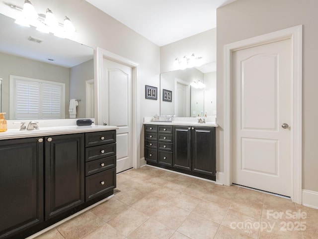 7040 Edenderry Dr, Charlotte, NC 28270 - bathroom with double vanity, tile patterned flooring, and baseboards