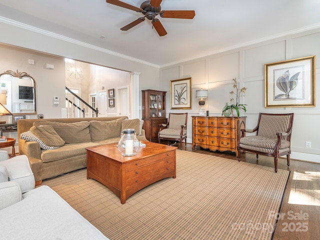 7040 Edenderry Dr, Charlotte, NC 28270 - living room featuring ceiling fan, ornamental molding, light wood finished floors, stairway, and a decorative wall