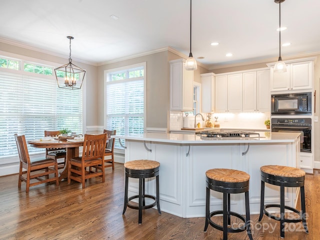 7040 Edenderry Dr, Charlotte, NC 28270 - kitchen with black appliances, ornamental molding, dark wood-style floors, white cabinetry, and tasteful backsplash