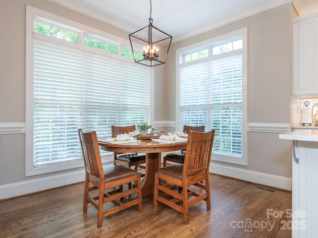 7040 Edenderry Dr, Charlotte, NC 28270 - dining area featuring crown molding, wood finished floors, a chandelier, and baseboards