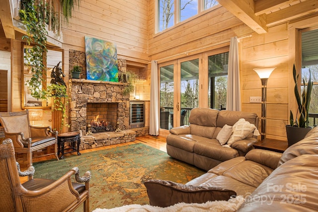 60 Laurel Ln, Mars Hill, NC 28754 - living area featuring wooden walls, wine cooler, a high ceiling, wood finished floors, and a fireplace