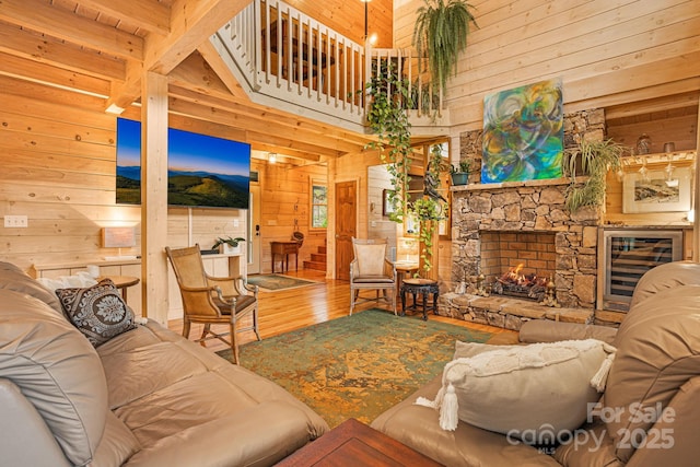 60 Laurel Ln, Mars Hill, NC 28754 - living area with wooden walls, wood finished floors, a towering ceiling, wine cooler, and an outdoor stone fireplace