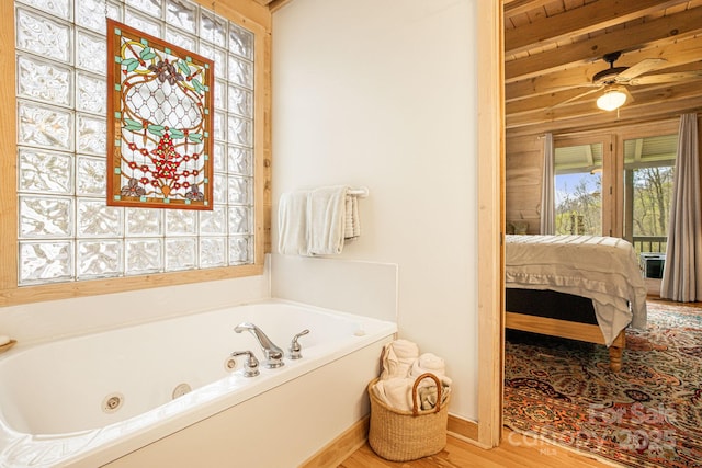 60 Laurel Ln, Mars Hill, NC 28754 - ensuite bathroom featuring a whirlpool tub, wood finished floors, and ceiling fan
